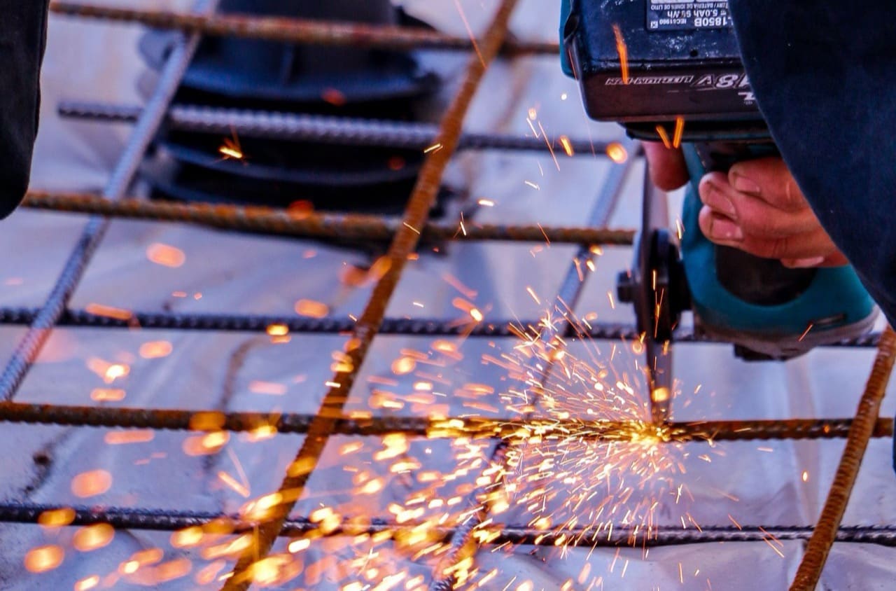 Handwerker trennt Stahl mit dem Winkelschleifer